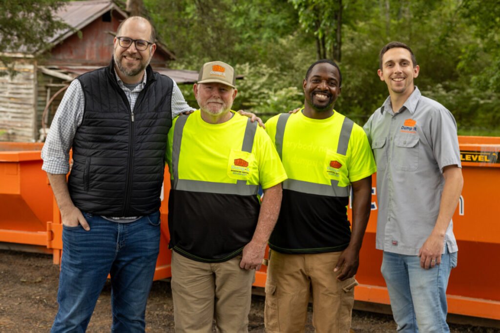 this image shows the joy and camaraderie of a healthy dumpster rental team